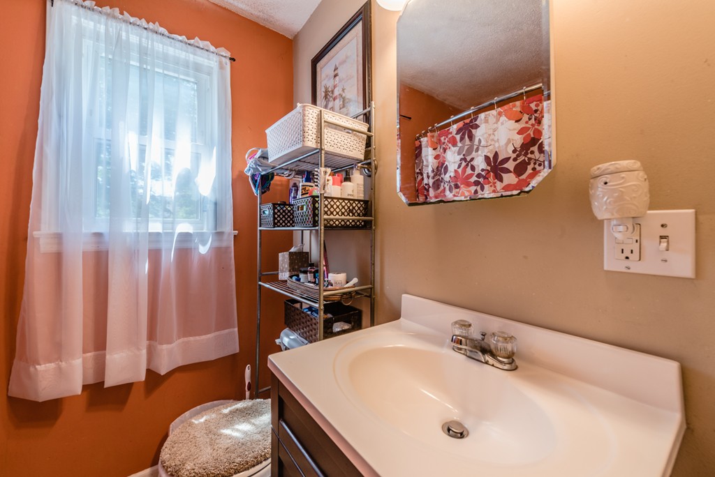 202 Rosewell Street Springfield, MA 01109 - Photo 17 of 25 a bathroom with a sink and a mirror