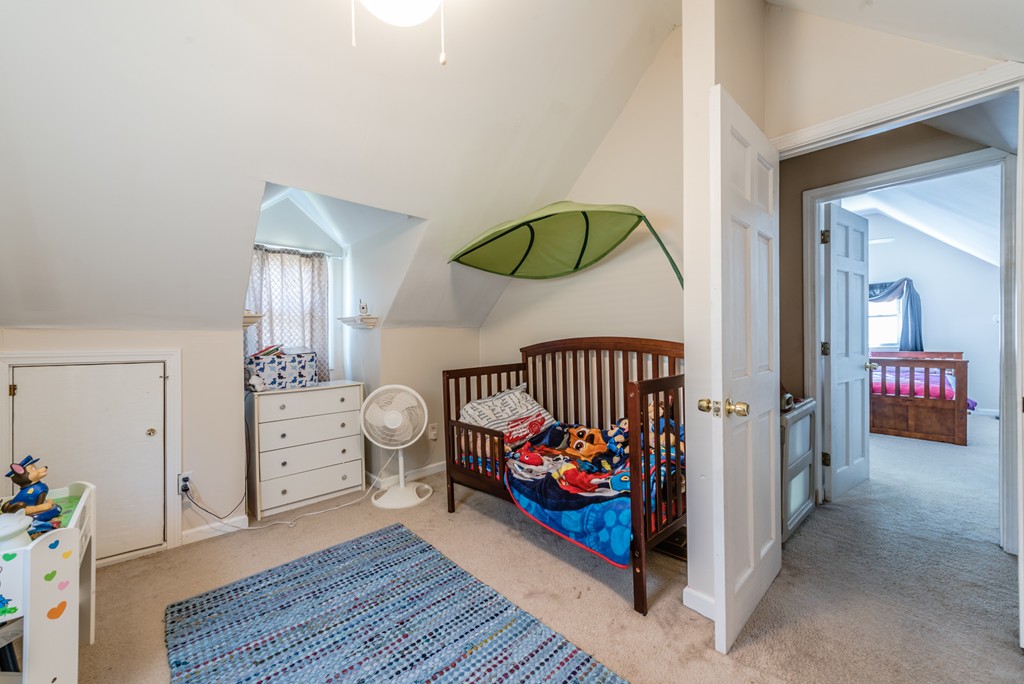 202 Rosewell Street Springfield, MA 01109 - Photo 20 of 25 wooden floor view with baby crib and a dresser