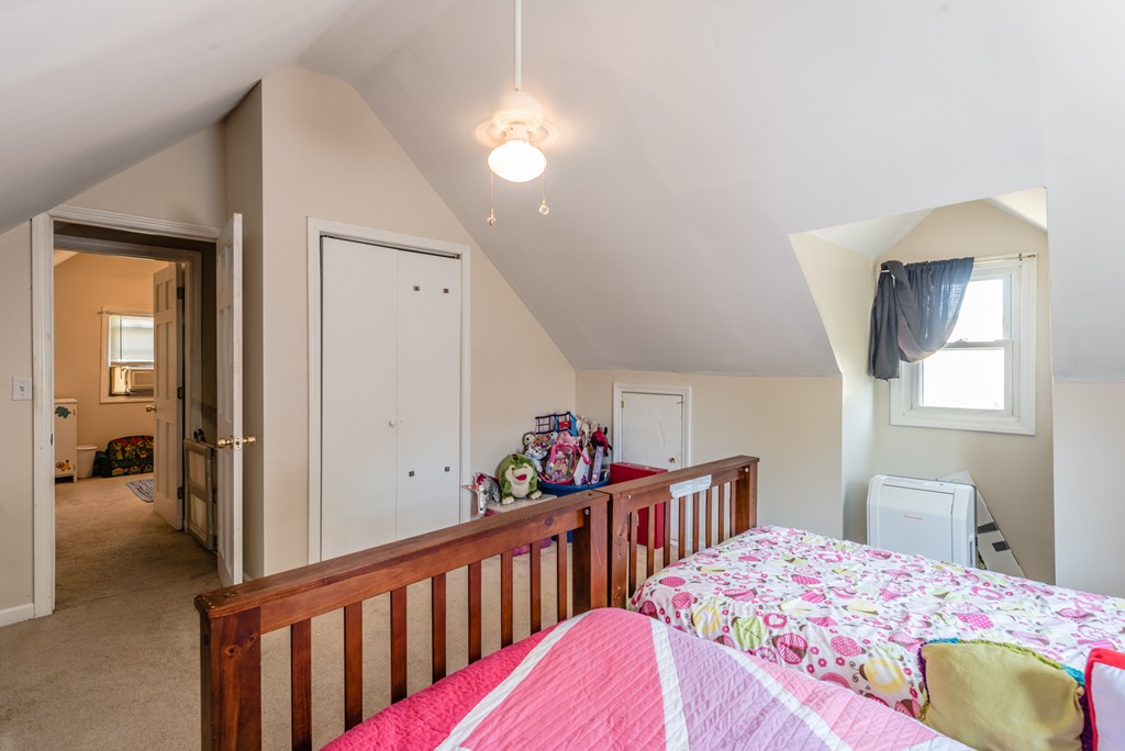 202 Rosewell Street Springfield, MA 01109 - Photo 24 of 25 a bedroom with a bed and a chandelier