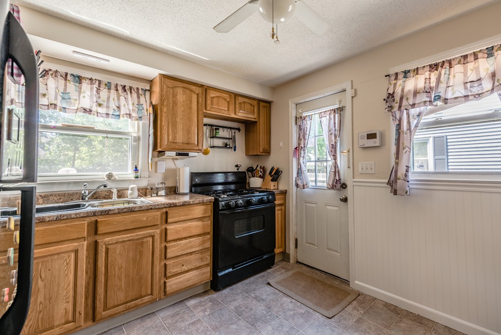 202 Rosewell Street Springfield, MA 01109 - Photo 5 of 25 a kitchen with a stove a sink and a window