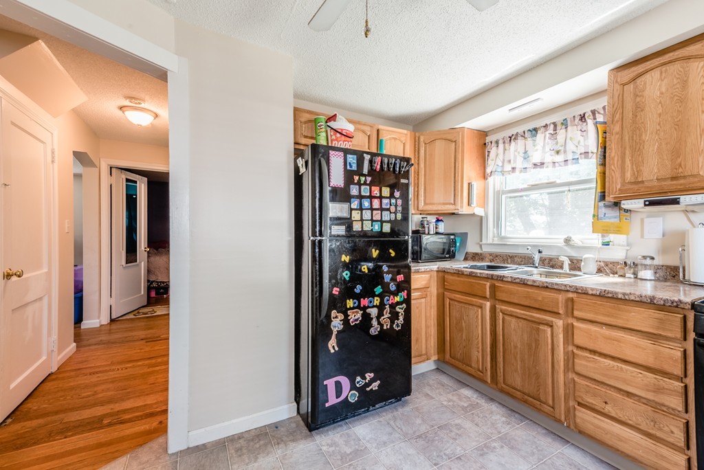 202 Rosewell Street Springfield, MA 01109 - Photo 6 of 25 a kitchen with stainless steel appliances granite countertop a refrigerator and a sink