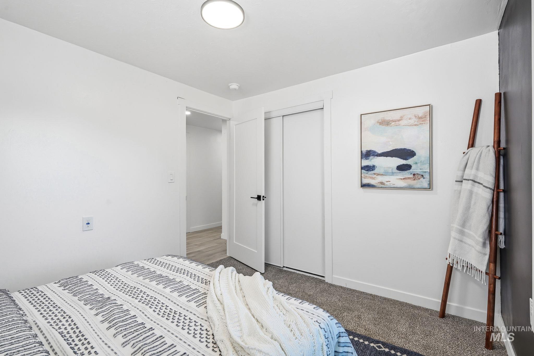 2152 Artesian Road Eagle, ID 83616 - Photo 25 of 50 Carpeted room featuring a ceiling-mounted light fixture, white walls, and a closet with sliding doors