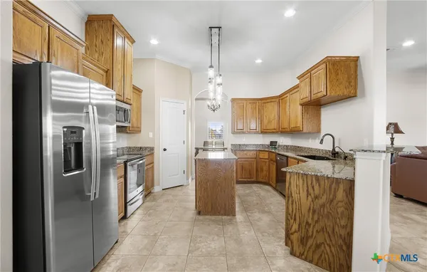 a kitchen with a sink stove and microwave