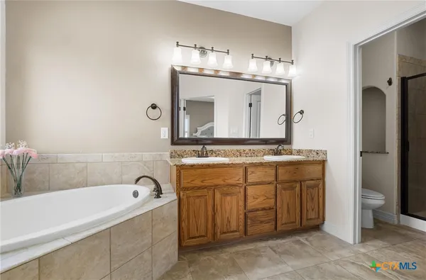 a bathroom with a double vanity sink and a mirror