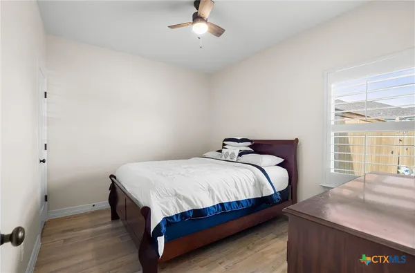 a bathroom with a granite countertop sink toilet a mirror and shower