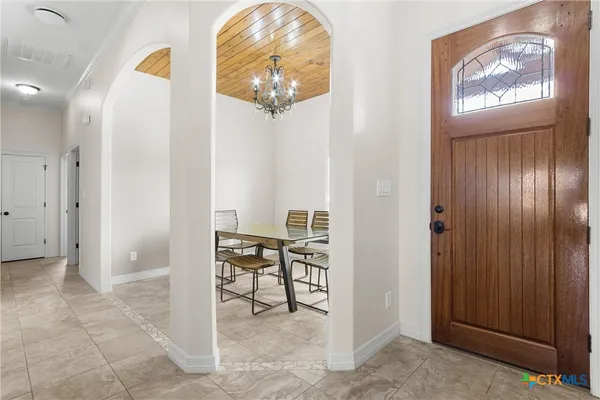 a view of a dining room with furniture and chandelier