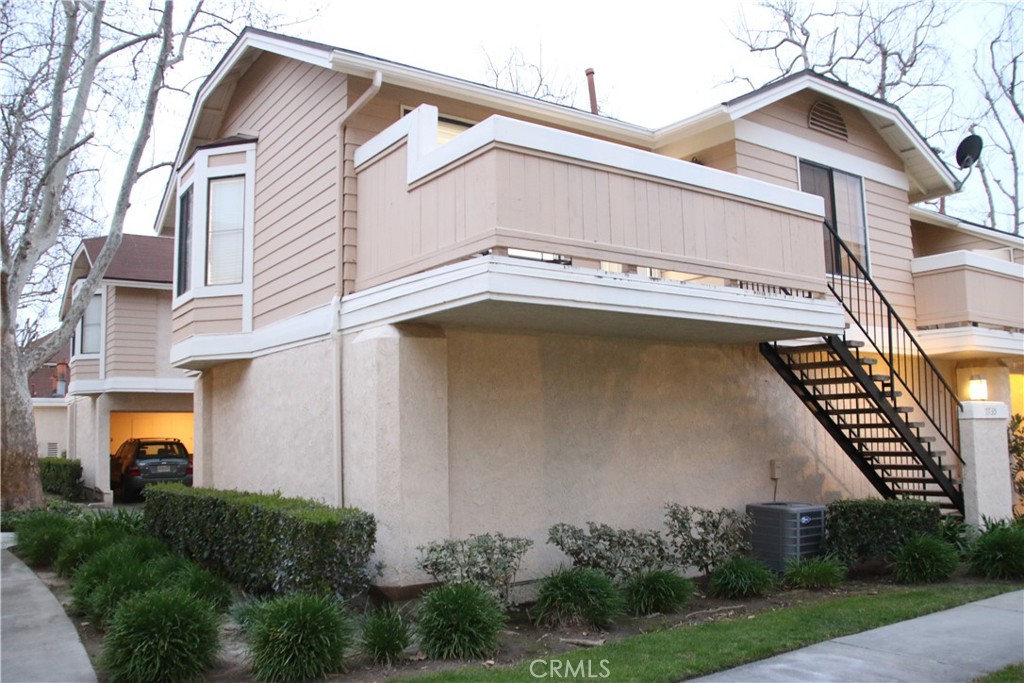 7735 Moordale Circle, Unit 246 Stanton, CA 90680 - Photo 19 of 21 a view of a building with a small yard