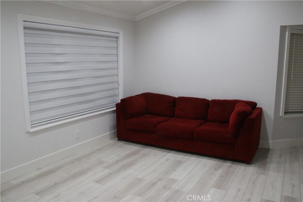 7735 Moordale Circle, Unit 246 Stanton, CA 90680 - Photo 3 of 21 a living room with furniture and a wooden floor
