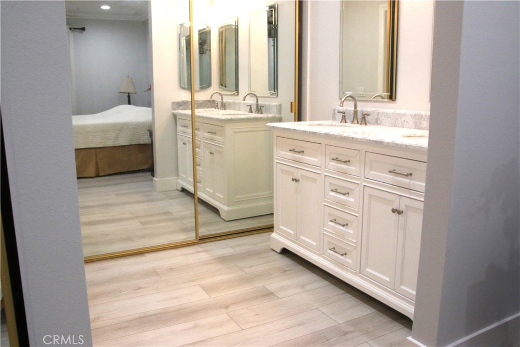 7735 Moordale Circle, Unit 246 Stanton, CA 90680 - Photo 8 of 21 a bathroom with a double vanity sink and mirror