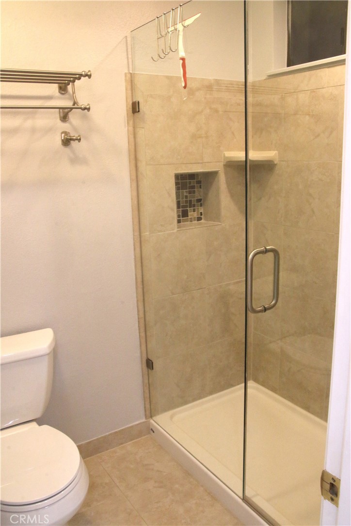 7735 Moordale Circle, Unit 246 Stanton, CA 90680 - Photo 9 of 21 a bathroom with a toilet and shower