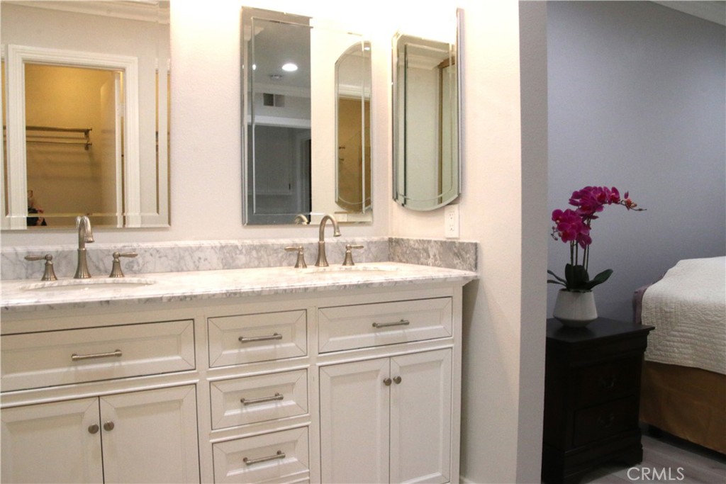 7735 Moordale Circle, Unit 246 Stanton, CA 90680 - Photo 10 of 21 a bathroom with a sink vanity and mirror