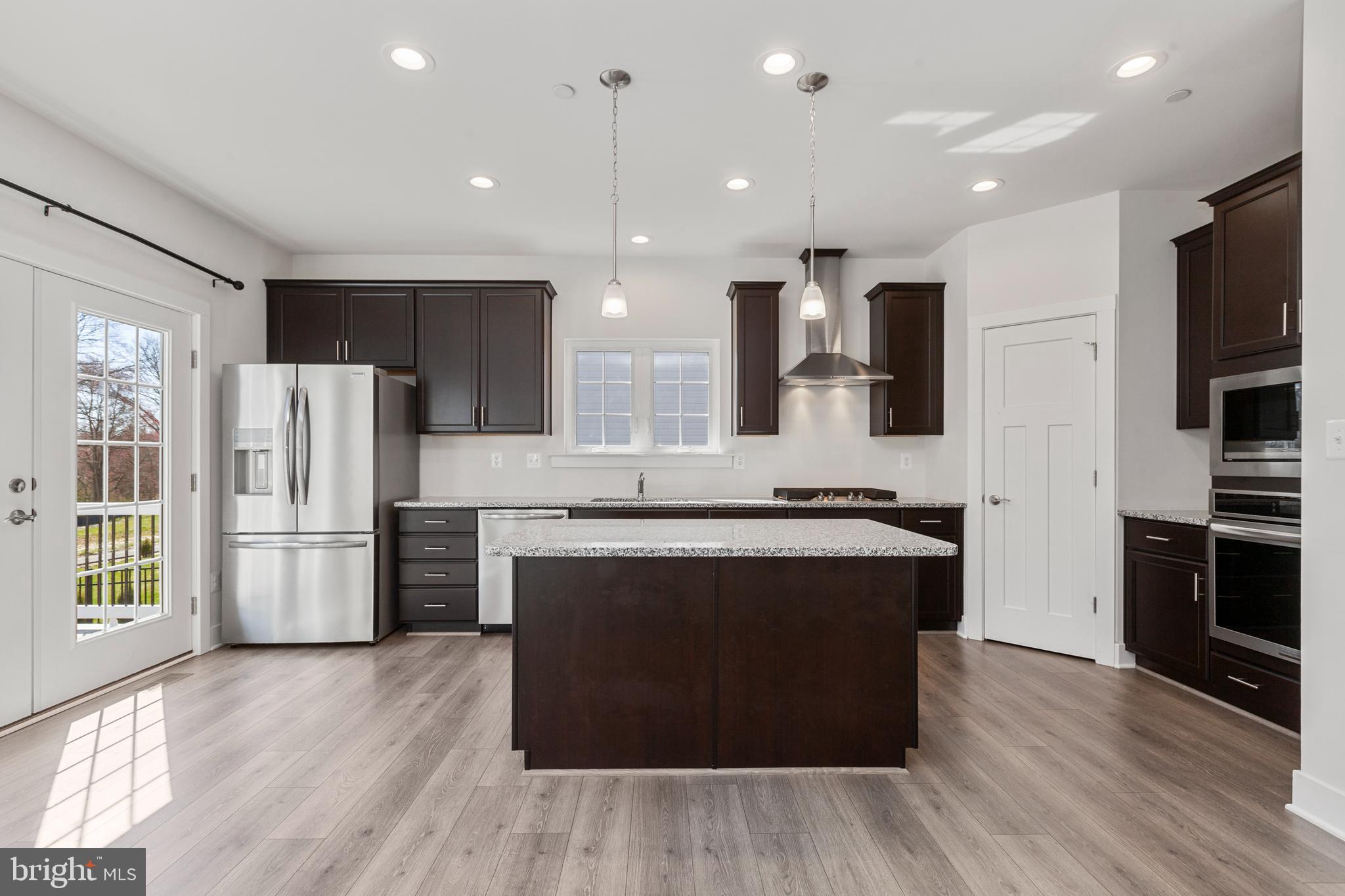 2517 Easy Street Fallston, MD 21047 - Photo 8 of 44 a large kitchen with stainless steel appliances granite countertop a stove and a refrigerator