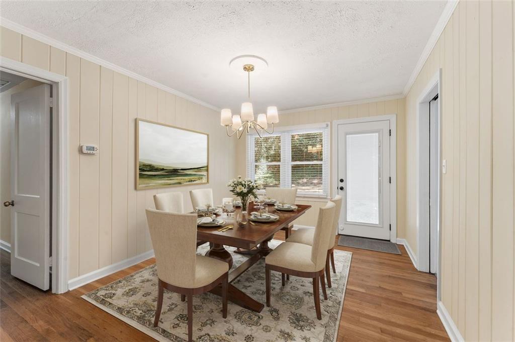 729 Timberland Street Smyrna, GA 30080 - Photo 11 of 26 a dining room with furniture a chandelier and wooden floor