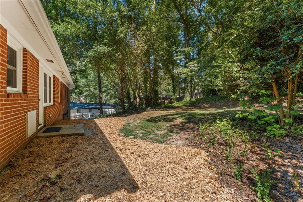 729 Timberland Street Smyrna, GA 30080 - Photo 23 of 26 a view of a yard with plants and trees