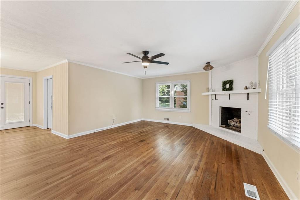 729 Timberland Street Smyrna, GA 30080 - Photo 9 of 26 an empty room with windows and a fireplace