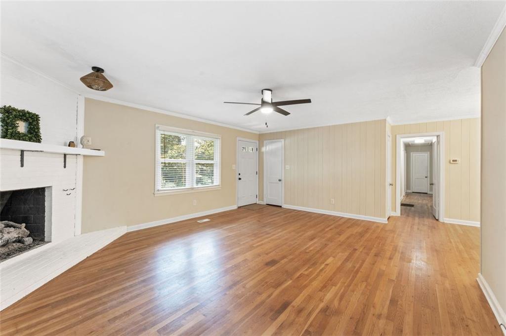 729 Timberland Street Smyrna, GA 30080 - Photo 10 of 26 a view of an empty room with wooden floor fireplace and a window
