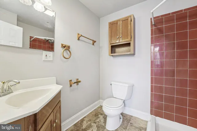 a bathroom with a sink a toilet and mirror