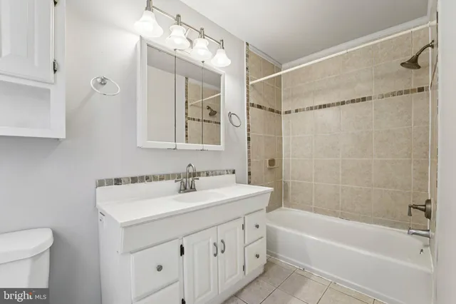 a bathroom with a sink mirror toilet and bathtub