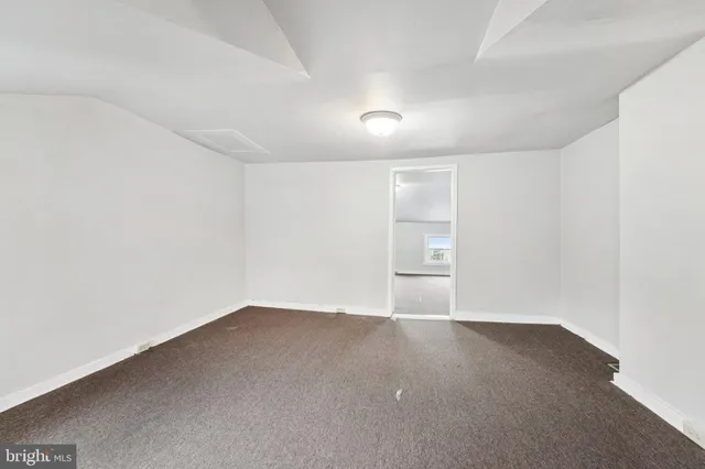 a bedroom with a bed lamp and window