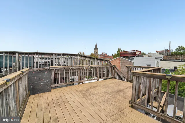 a view of a balcony with wooden floor