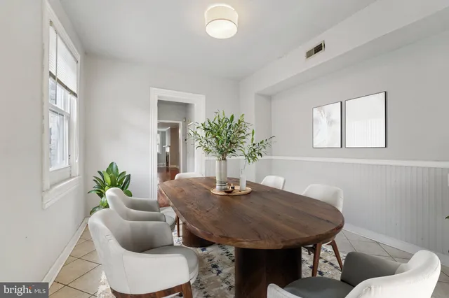 a dining room with furniture and wooden floor