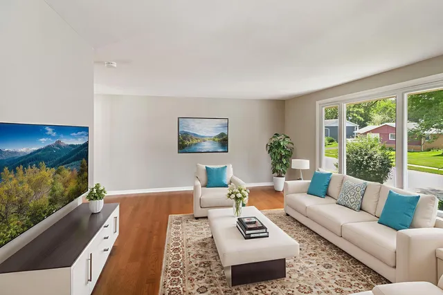 a living room with furniture and a large window