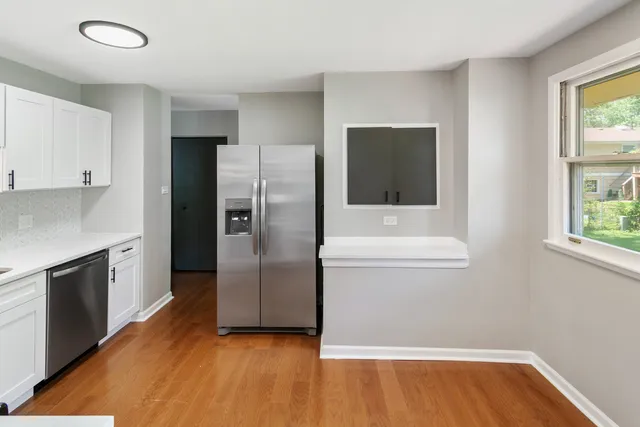 a kitchen with a refrigerator and a sink