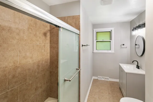 a bathroom with a toilet a sink and a mirror