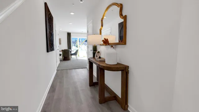 a view of entryway and hall with wooden floor