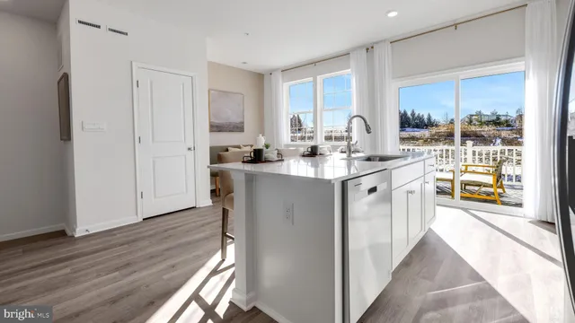 a kitchen with sink cabinets and wooden floor