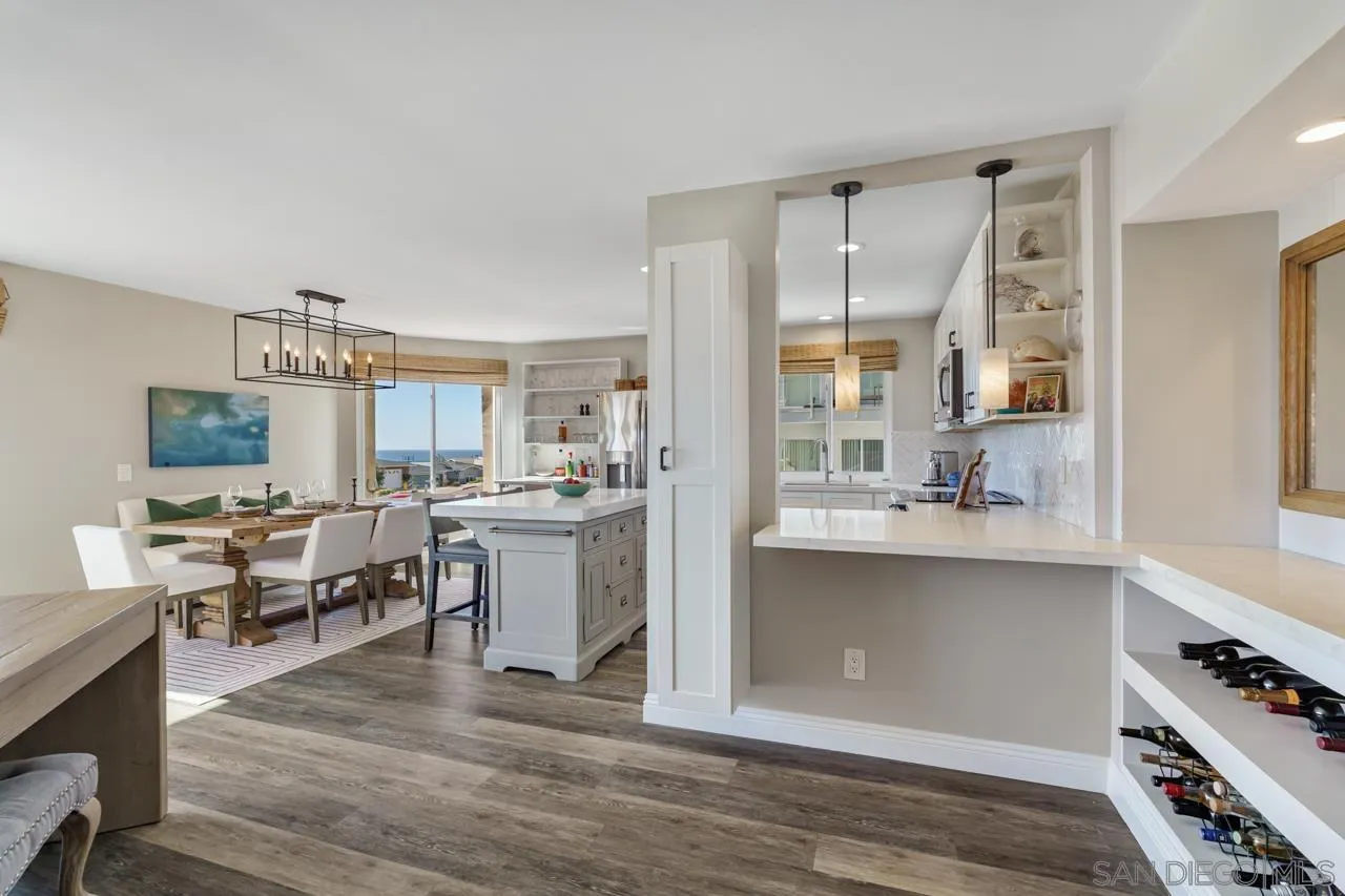 5366 La Jolla Boulevard, Unit 101C La Jolla, CA 92037 - Photo 14 of 41 a large white kitchen with cabinets and wooden floor