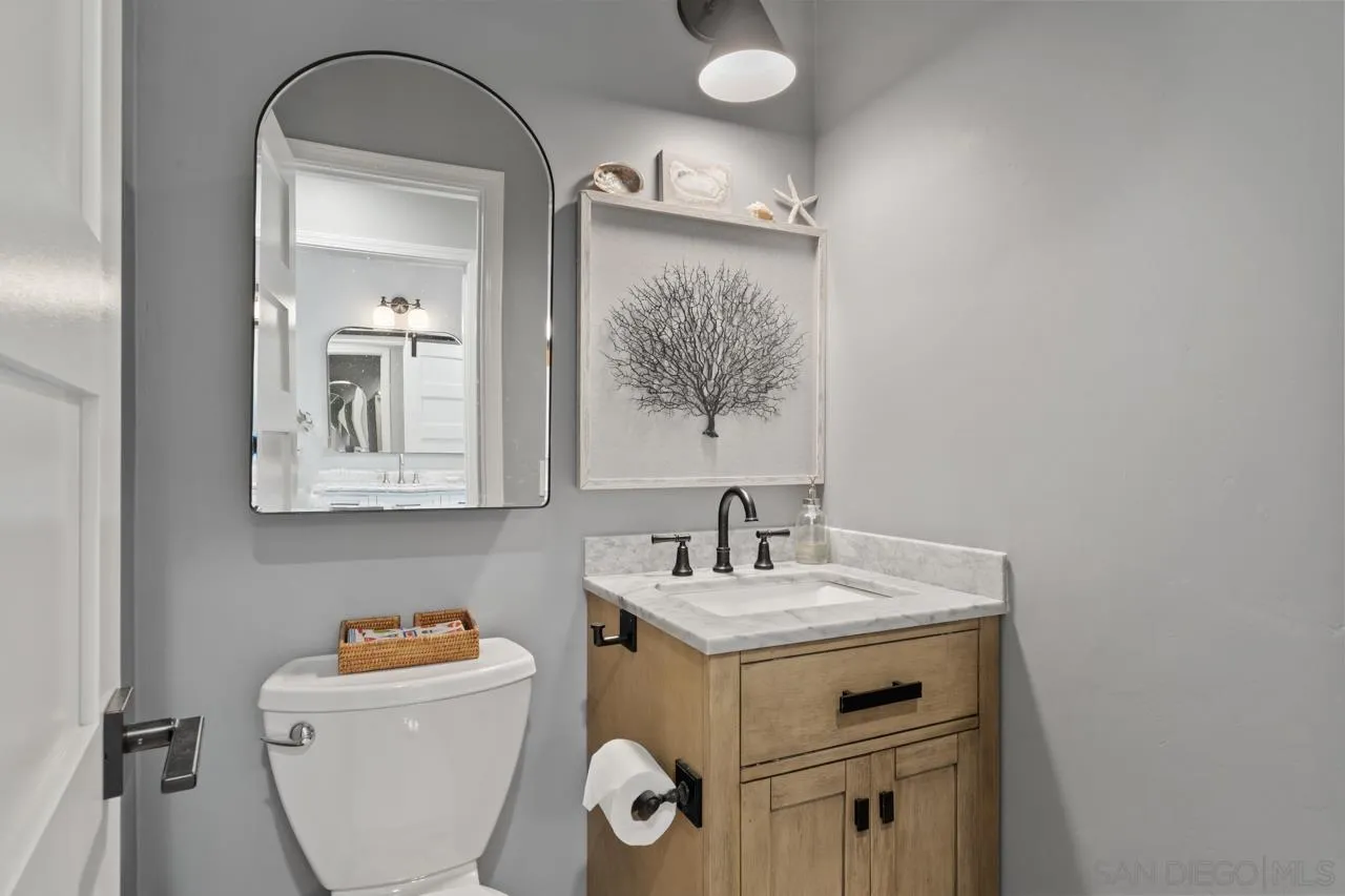5366 La Jolla Boulevard, Unit 101C La Jolla, CA 92037 - Photo 28 of 41 a bathroom with a sink mirror and vanity