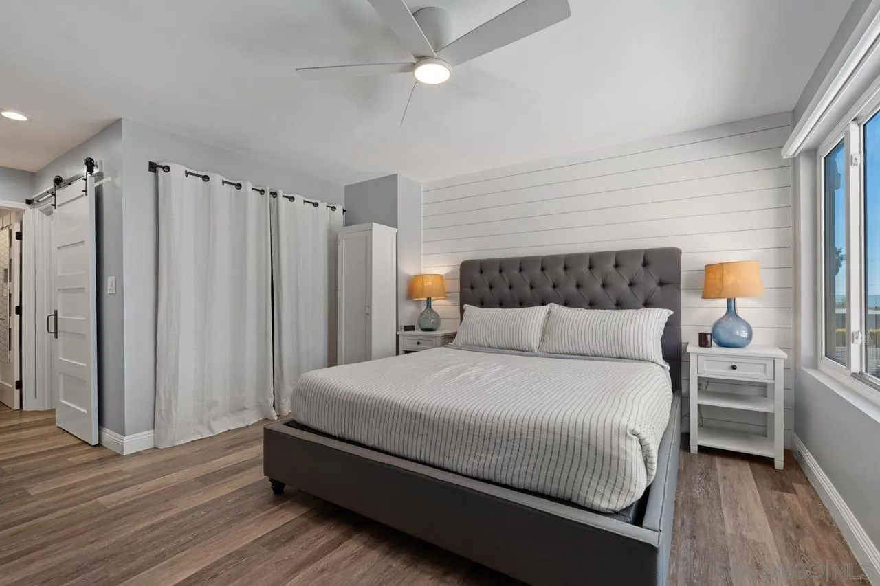 5366 La Jolla Boulevard, Unit 101C La Jolla, CA 92037 - Photo 30 of 41 a bedroom with a bed and a window