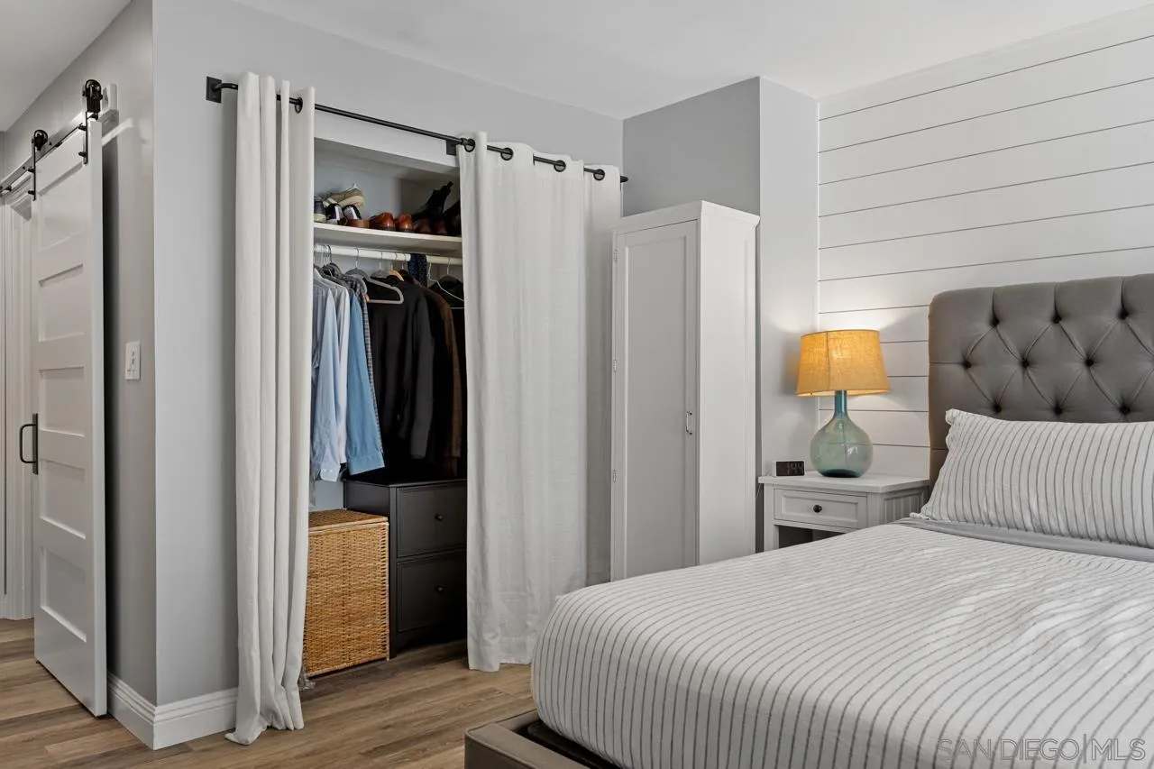 5366 La Jolla Boulevard, Unit 101C La Jolla, CA 92037 - Photo 31 of 41 a bedroom with a bed and a refrigerator