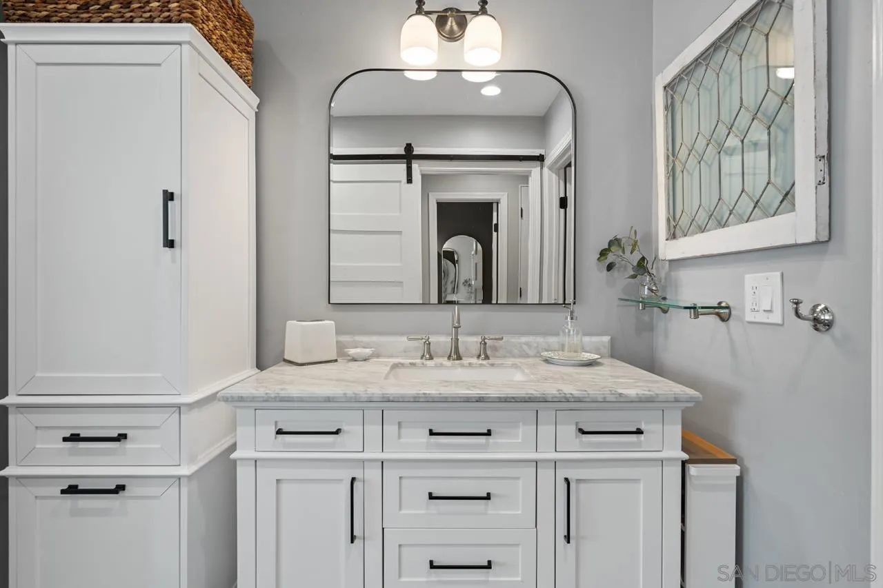 5366 La Jolla Boulevard, Unit 101C La Jolla, CA 92037 - Photo 32 of 41 a bathroom with a sink vanity and a mirror
