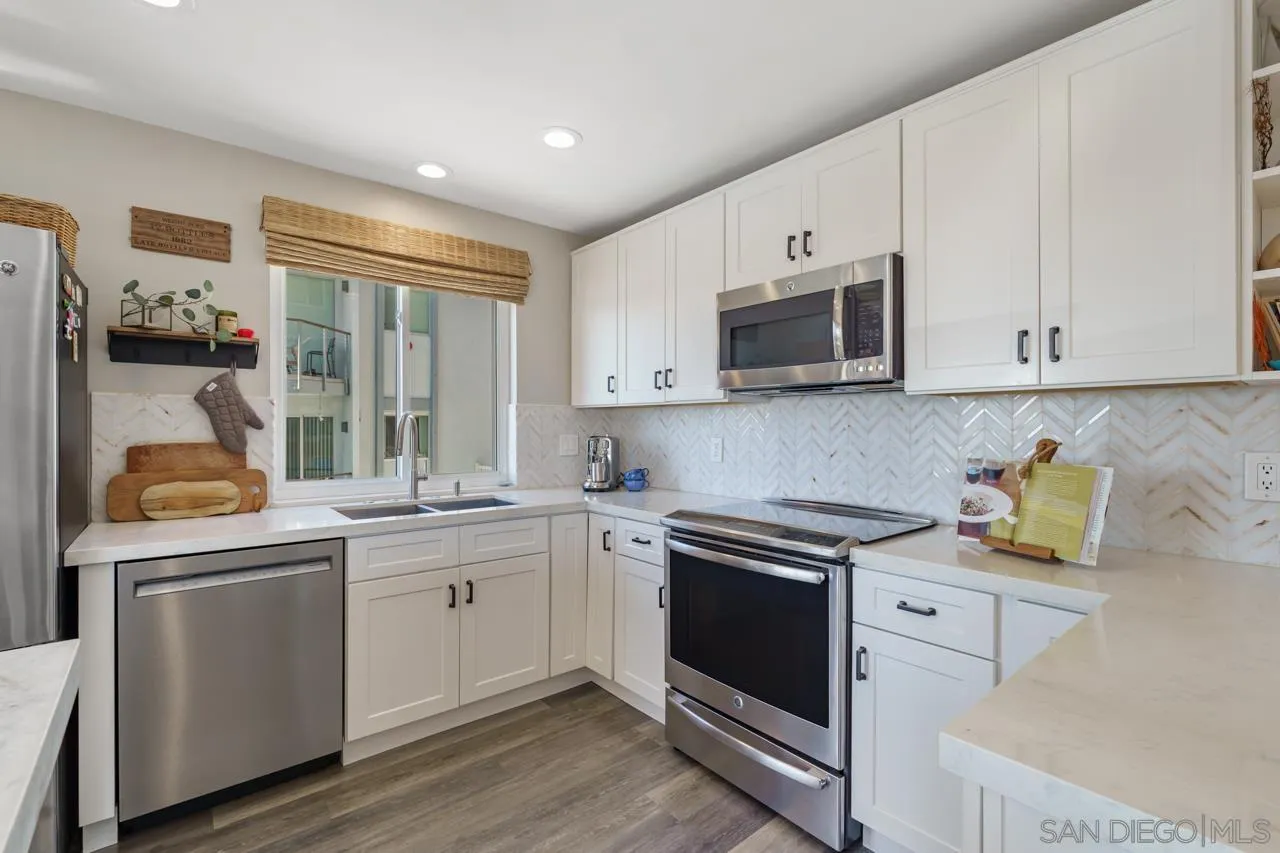 5366 La Jolla Boulevard, Unit 101C La Jolla, CA 92037 - Photo 5 of 41 a kitchen with stainless steel appliances granite countertop a sink and a stove top oven
