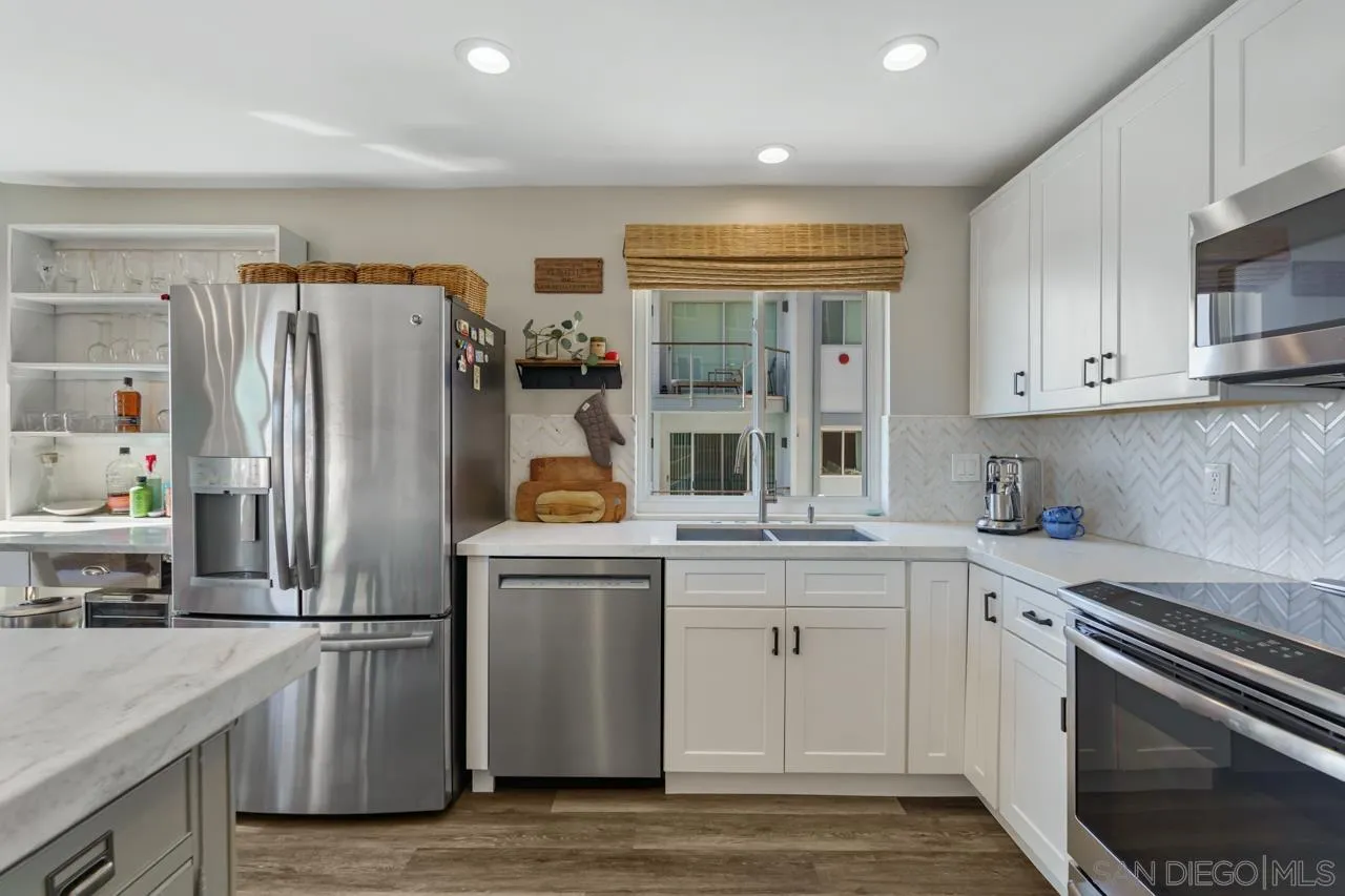5366 La Jolla Boulevard, Unit 101C La Jolla, CA 92037 - Photo 7 of 41 a kitchen with stainless steel appliances granite countertop a refrigerator a stove and a sink