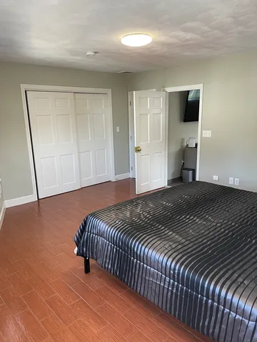 a bedroom with a bed and mirror