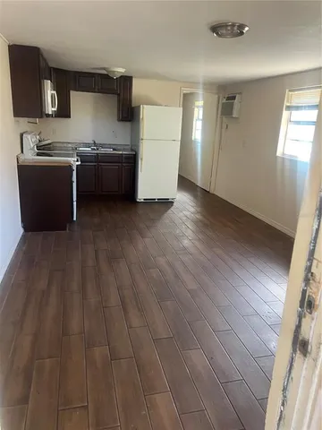 a kitchen with stainless steel appliances granite countertop a sink stove and wooden floor