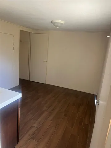 a view of a room with wooden floor