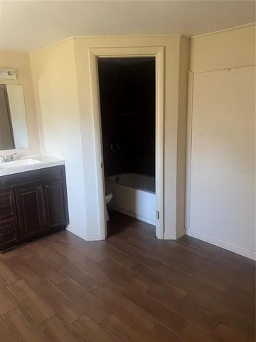 a view of an empty room and wooden floor