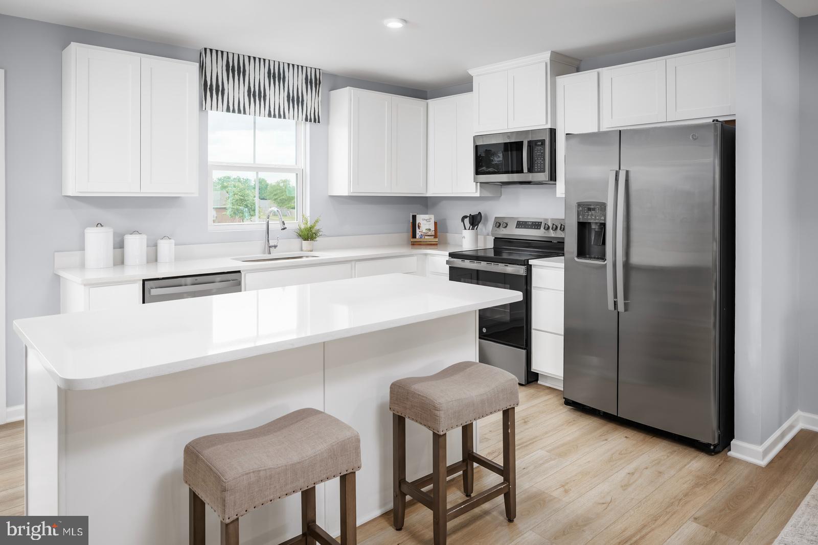 2204 Mutual Drive Inwood, WV 25428 - Photo 6 of 20 a kitchen with a refrigerator and a stove top oven