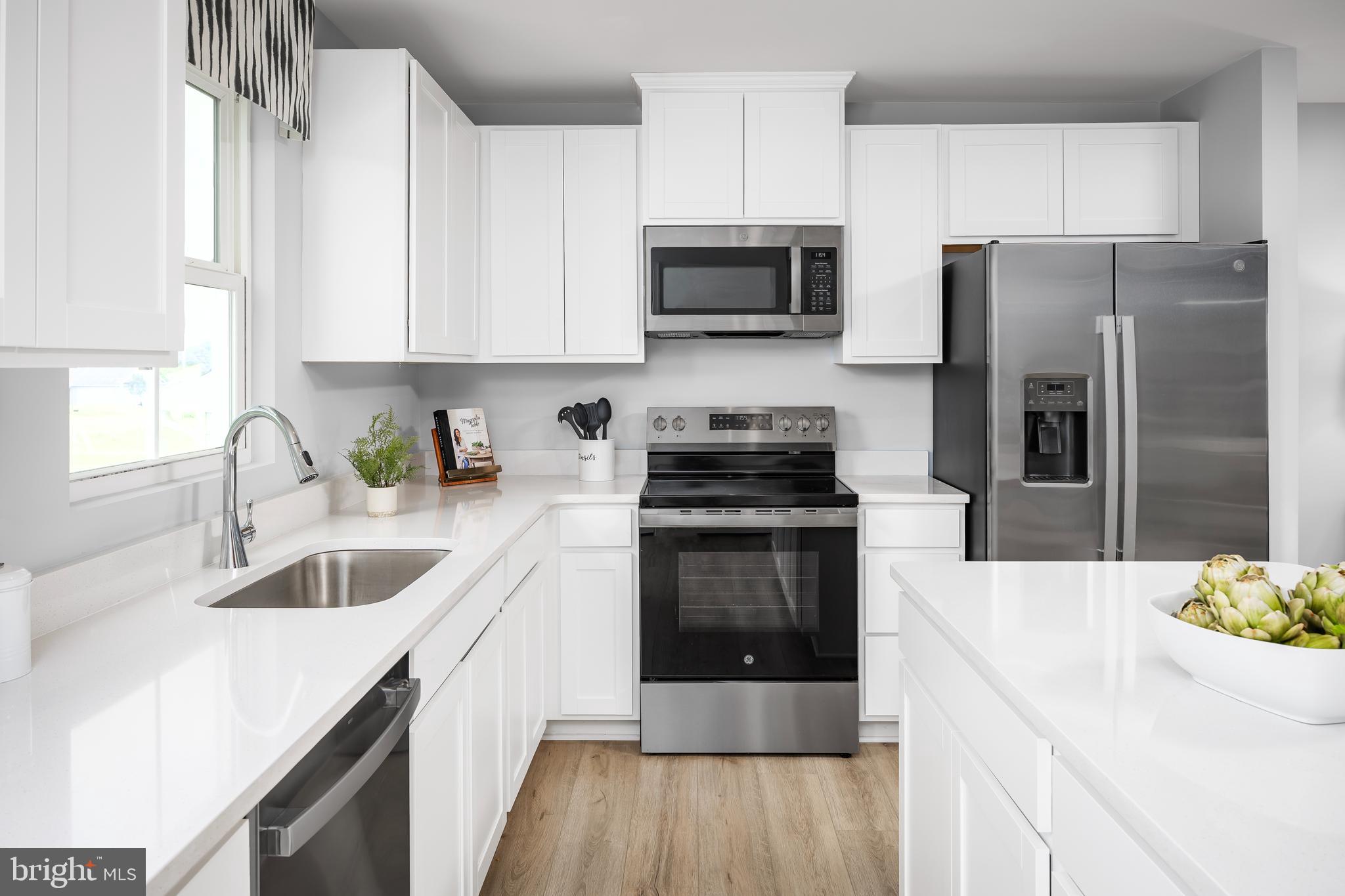 2204 Mutual Drive Inwood, WV 25428 - Photo 7 of 20 a kitchen with a sink white cabinets and stainless steel appliances