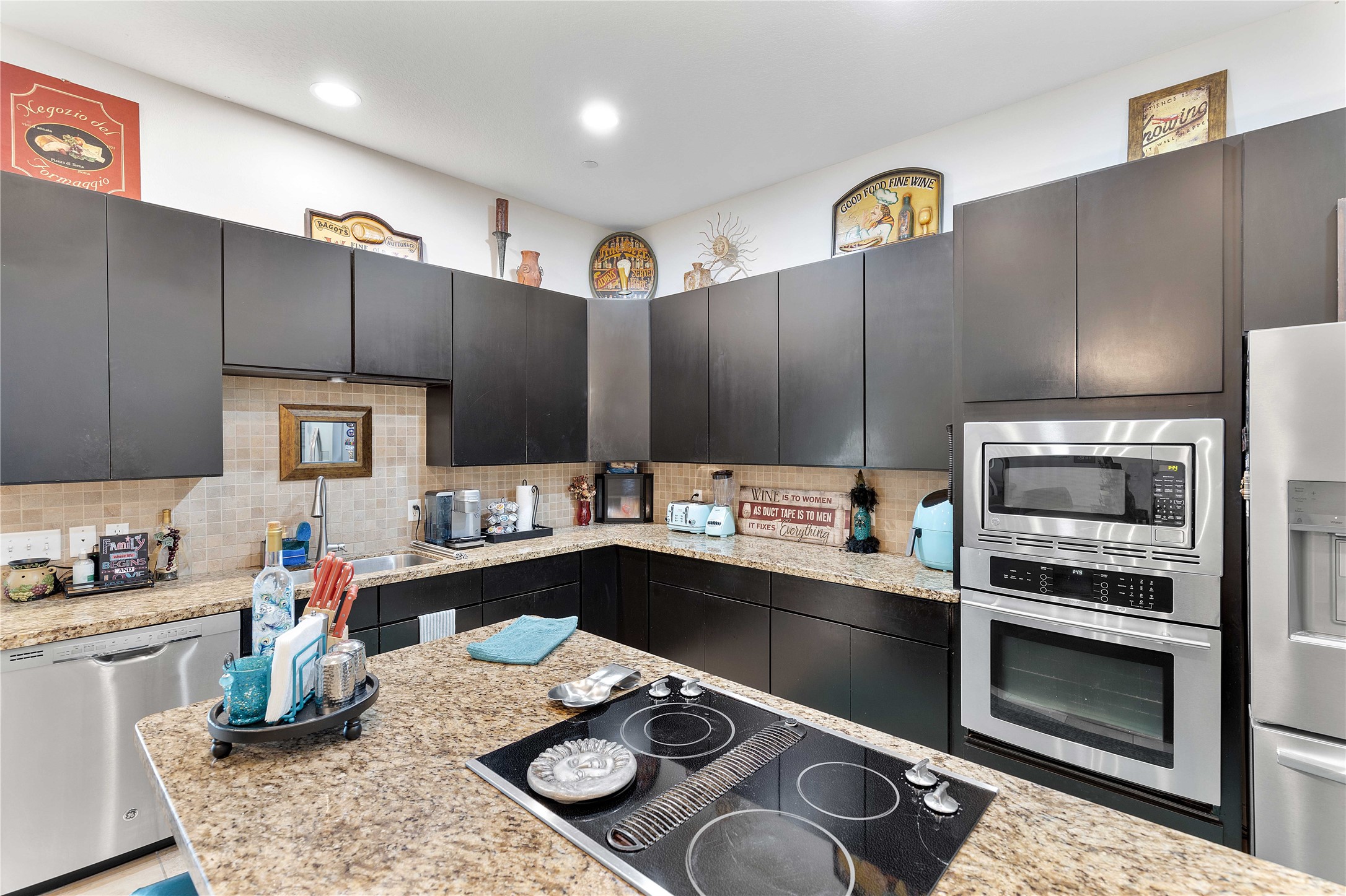 11434 Ketch Court Willis, TX 77318 - Photo 24 of 50 a kitchen with sink refrigerator and stove