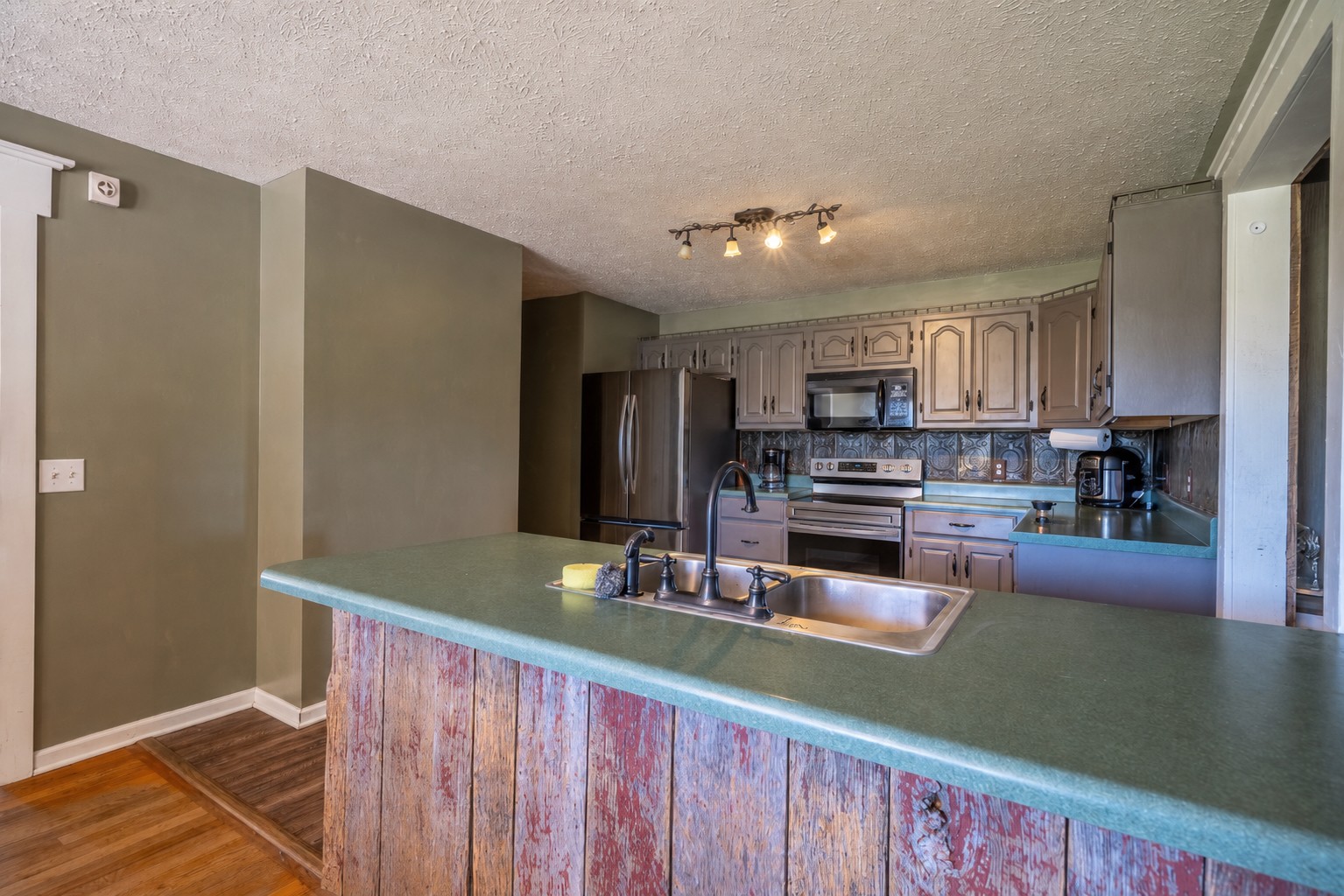 11220 Shelbyville Road Morrison, TN 37357 - Photo 10 of 67 a kitchen with stainless steel appliances granite countertop a refrigerator and a stove top oven