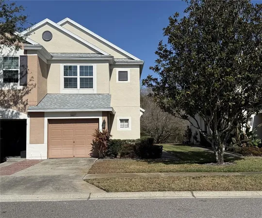a front view of a house with a yard and garage