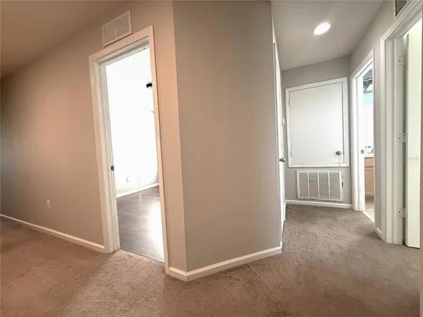 an empty room with closet and a bathroom