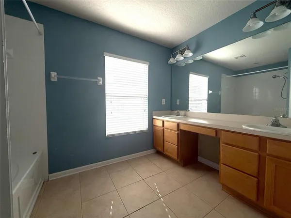 a large bathroom with a large tub sink and window