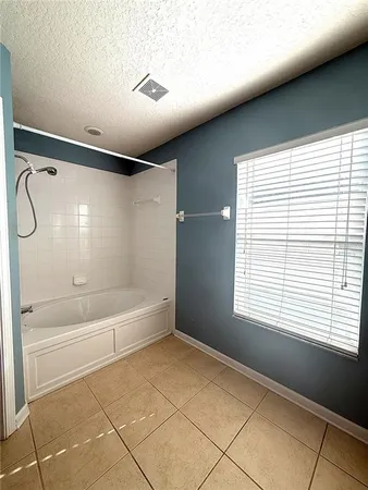 a spacious bathroom with a bathtub and a shower