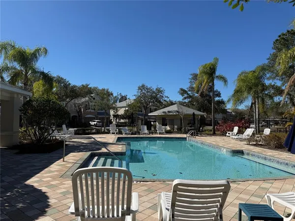 a view of swimming pool with outdoor seating and lake view